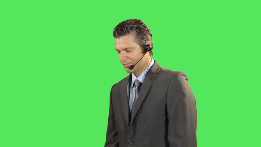 Business male talking on headset  on greenscreen
