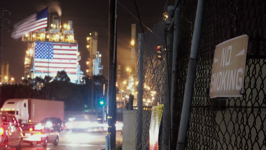  Timelapse of factory with US flag and fence, California.