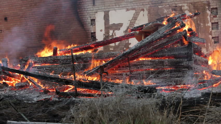 House burns in flames after roof collapse with old adobe bricks walls. Timber and wood structure in blaze of flames. Total destruction. Now insurance is responsible.