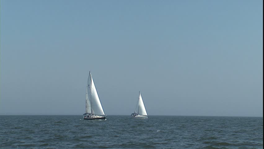 sailboats under sail in Chesapeake bay during mid day sun with slight haze, Annapolis, MD