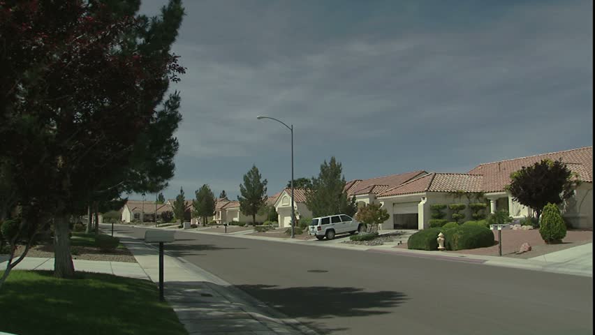 suburban las Vegas neighborhood, car pulls out of driveway and drives away, Nevada