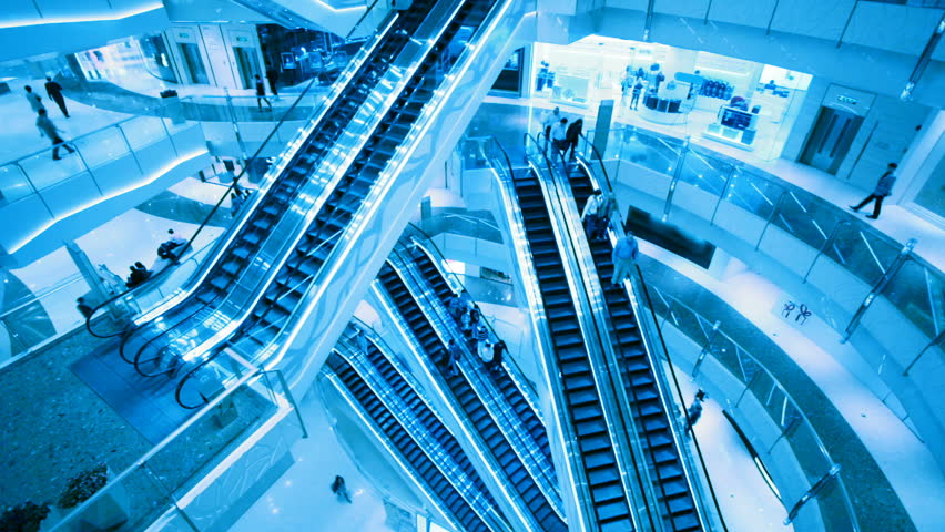 Escalators in shop. City life background.