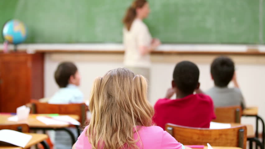 Teacher wiping the chalkboard in the classroom