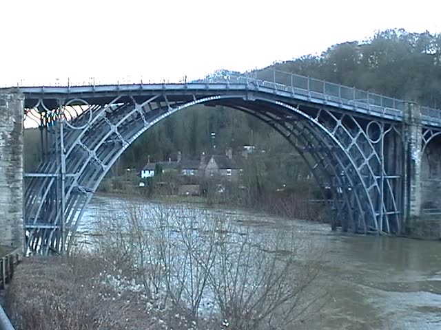 The Iron Bridge crosses the River Severn at the Ironbridge Gorge, by the village of Ironbridge, in Shropshire, England. It was the first bridge in the world to be made out of cast iron