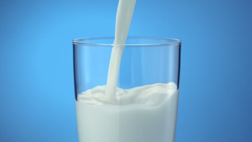 Milk pouring into glass shooting with high speed camera, phantom flex.