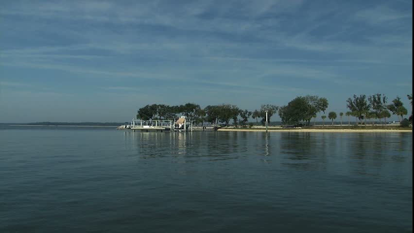 dock and sand bar, pan up to waterway