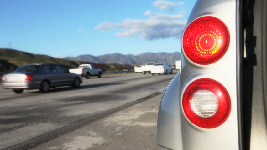 Car pulled off to the side of the road with Hazard lights blinking