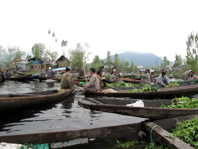 SRINAGAR, INDIA - APRIL 14: Kashmiri men sell their vegetables at a floating market in the early hours before sunrise on April 14, 2012 in Dal Lake, Srinagar, Jammu and Kashmir, India.