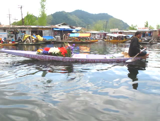 SRINAGAR, INDIA - APRIL 14: Mr. Wonderful Flower Man sells flowers from his small boat on April 14, 2012 in Dal Lake, Srinagar, Jammu and Kashmir, India.