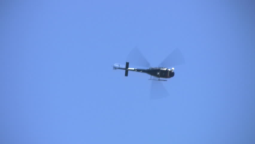 A helicopter flies overhead.