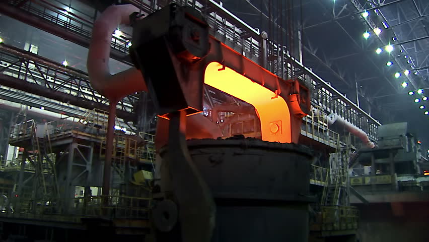 Iron and Steel Works. A huge crane transports the ladle of molten metal.