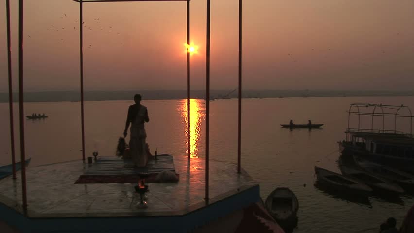 religious leader offering prayers with Ganges river and rising sun.Circa November, 2008, Veranasi, India