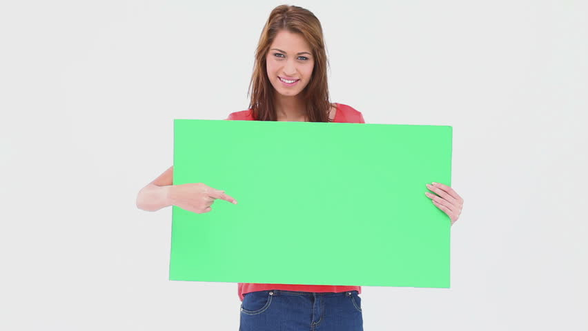 Woman holding and pointing a blank poster against white background