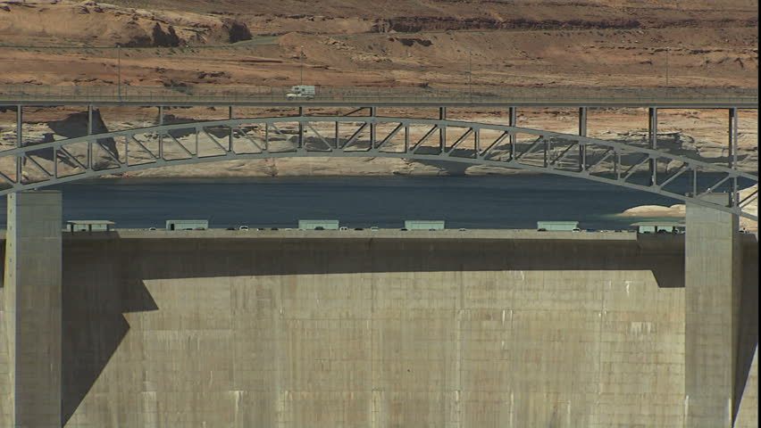 lake Powell behind glen canyon dam, zoom out to reveal Colorado river and dam