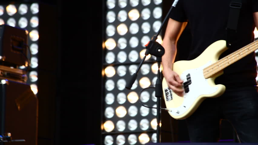 A bass guitar in live action at a concert