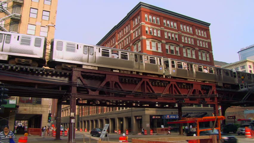 CHICAGO CIRCA FEBRUARY 2011: Downtown area with El Train traveling by buildings passing through frame over road construction with sound.