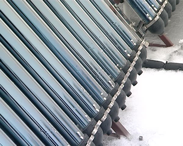 solar collectors on roof of private house in winter. alternative renewable electricity generation.