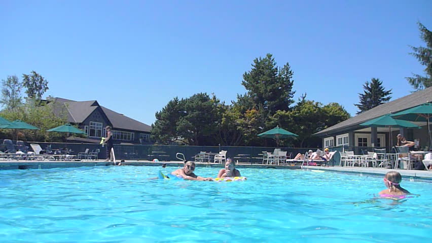 Man jumps into swimming pool and does a cannonball.