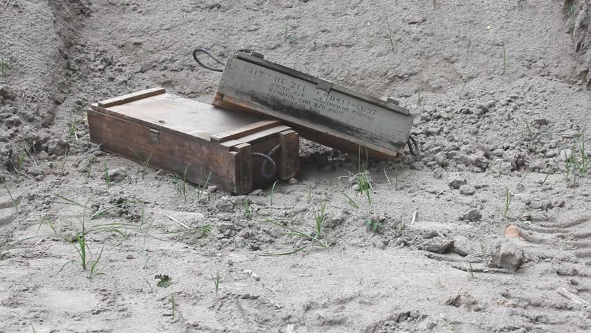 Discarded Military Metal Canister Thrown In Front Of Empty Discarded Crates