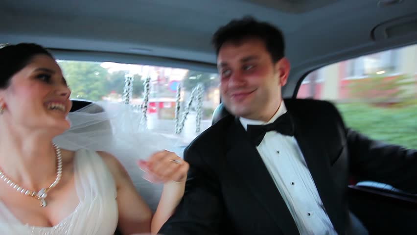 bride and groom dance in the car 