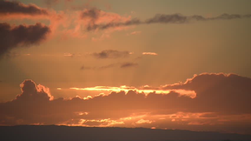 Beautiful timelapsed sunrise through the many layers of clouds. (High Definition)