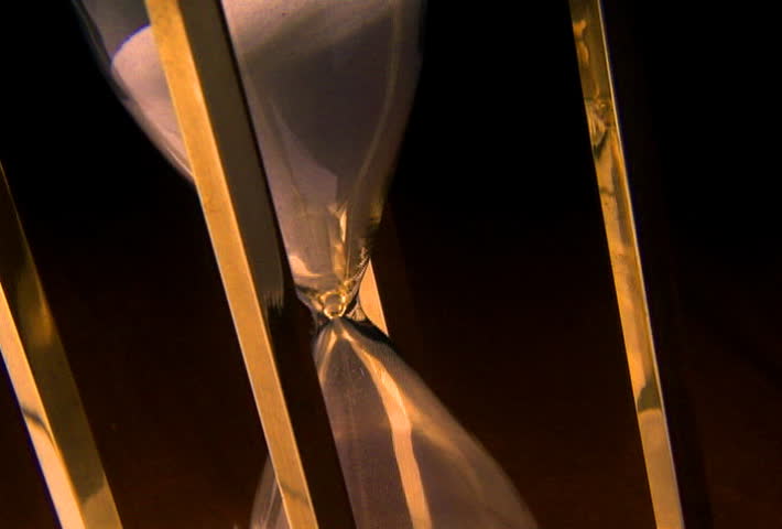 Time passes as sand slips through hourglass