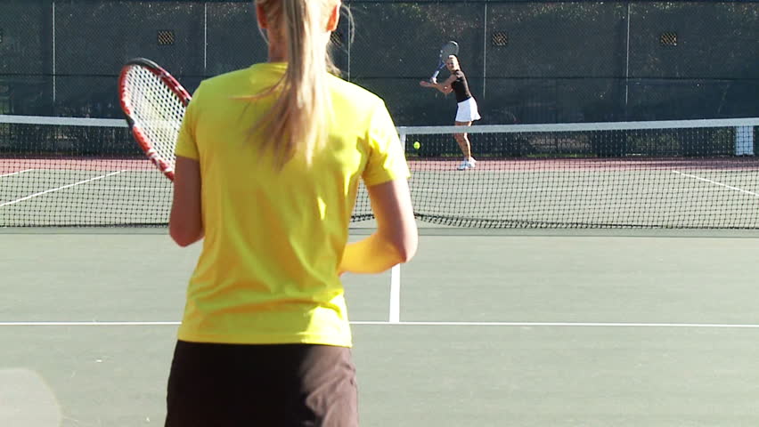 Full court tennis game in slow motion