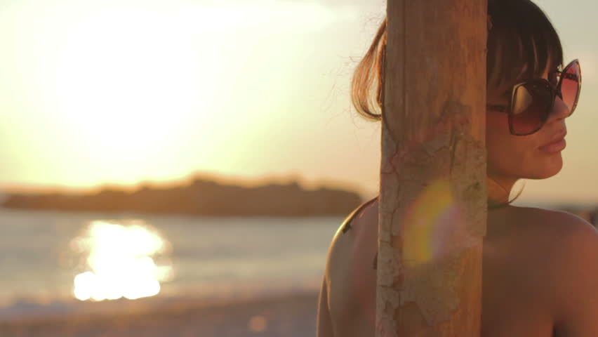 Portrait of a beautiful woman in bikini on the beach.