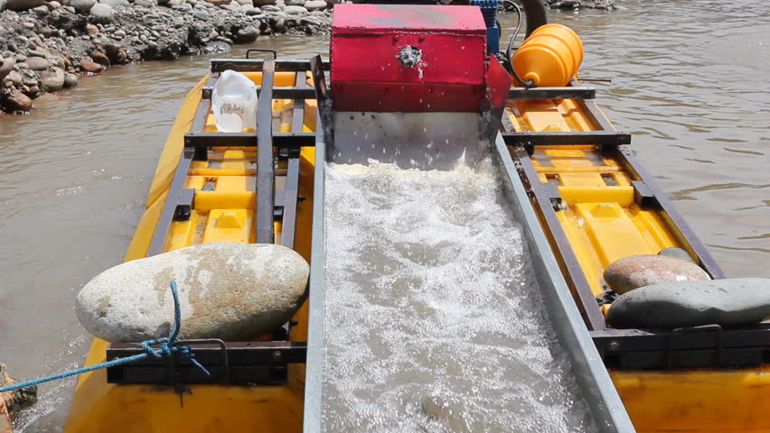 Suction dredge mining placer gold deposits on the Rio Napo in the Ecuadorian Amazon.