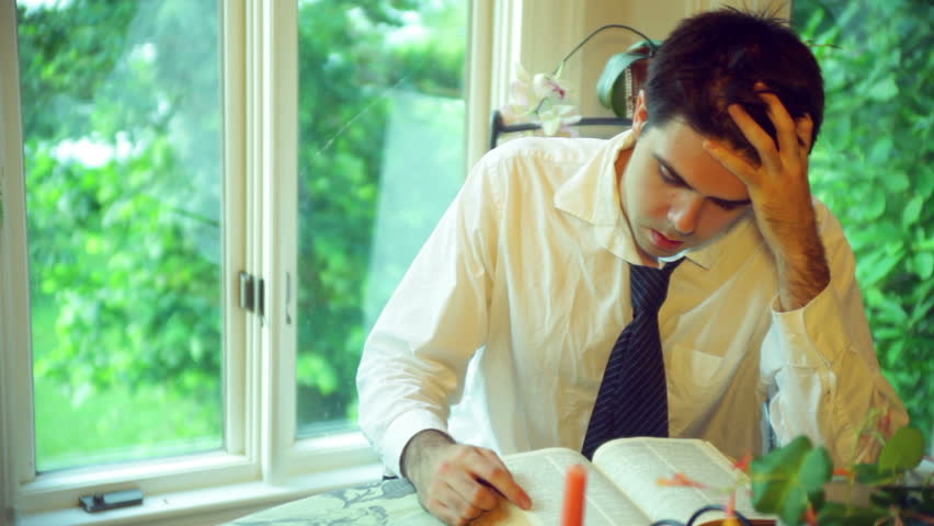 Depressed business man reading the bible