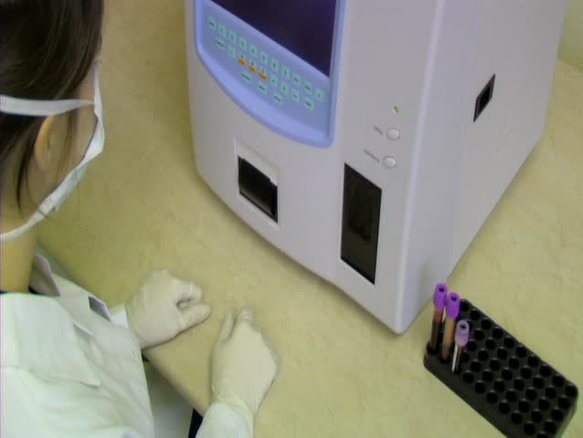 PRAGUE - APRIL 11: Doctor uses machine to analyze blood sample. April 11th, 2007, Prague, Czech Republic