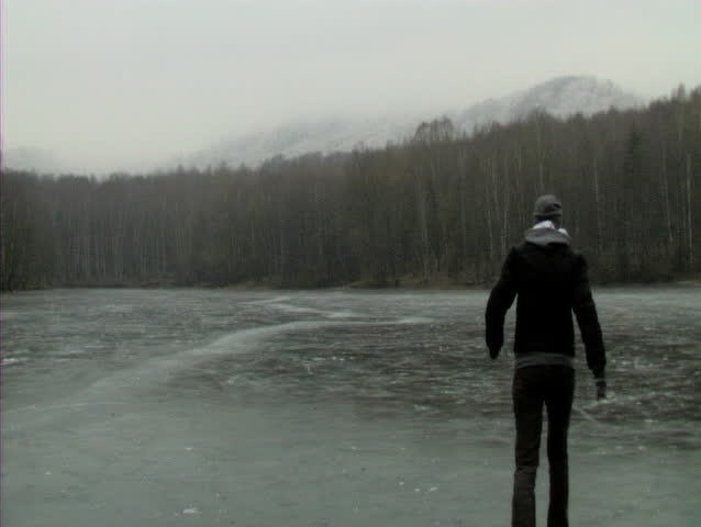 USTI NAD LABEM, CZECH REPUBLIC - FEBRUARY 28: Woman walking on a frozen lake in Usti nad labem, CZ February 28, 2008