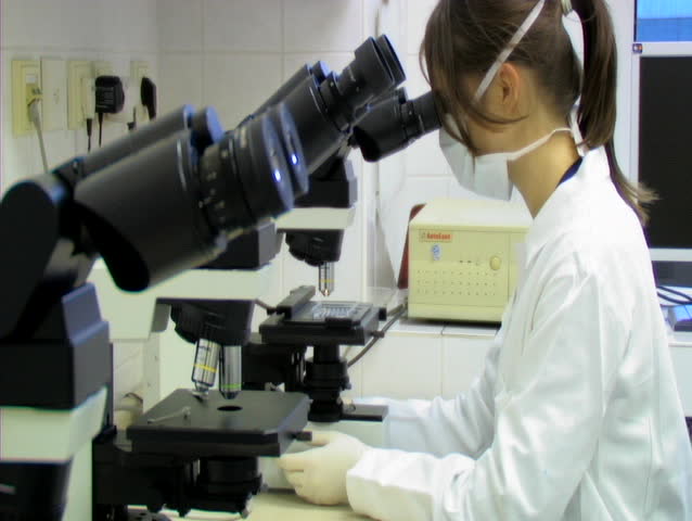PRAGUE - APRIL 11: Doctor uses microscope to analyze blood sample. April 11th, 2007, Prague, Czech Republic