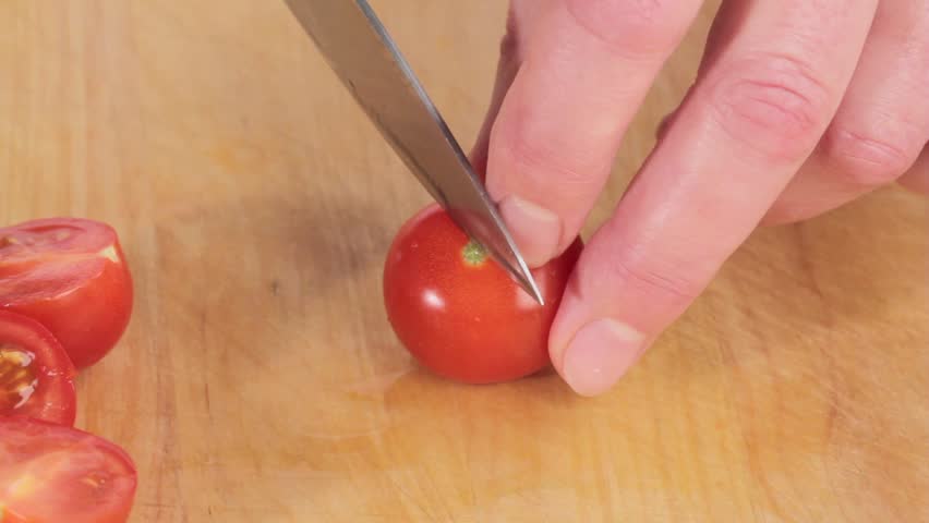 Cherry tomatoes being halved