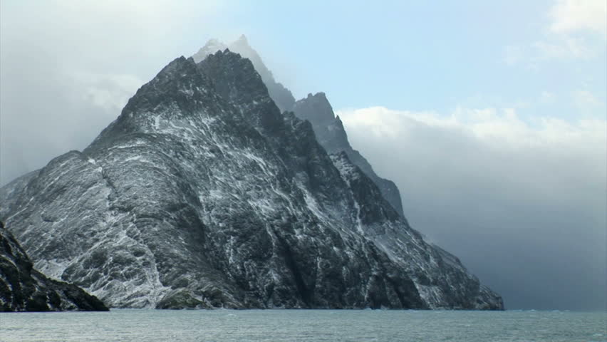 South Georgia and the South Sandwich Islands: expedition ship passing icebergs and mountain.
