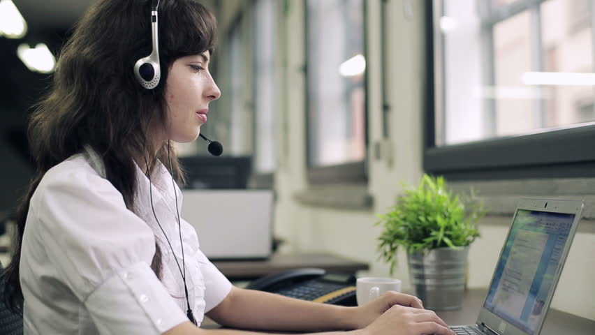Friendly happy female helpdesk consultant in the office
