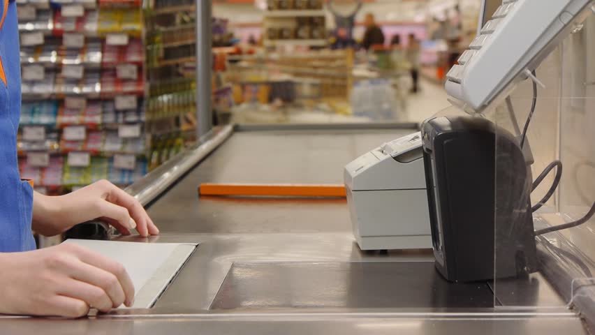 cashier counts money in supermarket