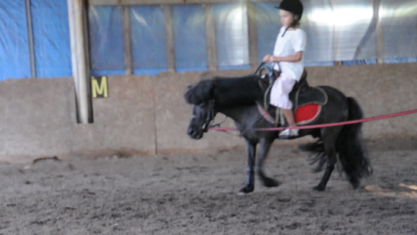 Child riding a pony