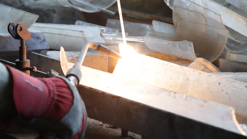 Close-up of quartz and glass welding made with gas high temperature machine. Flame is heating quartz till red colour and it starts melting.