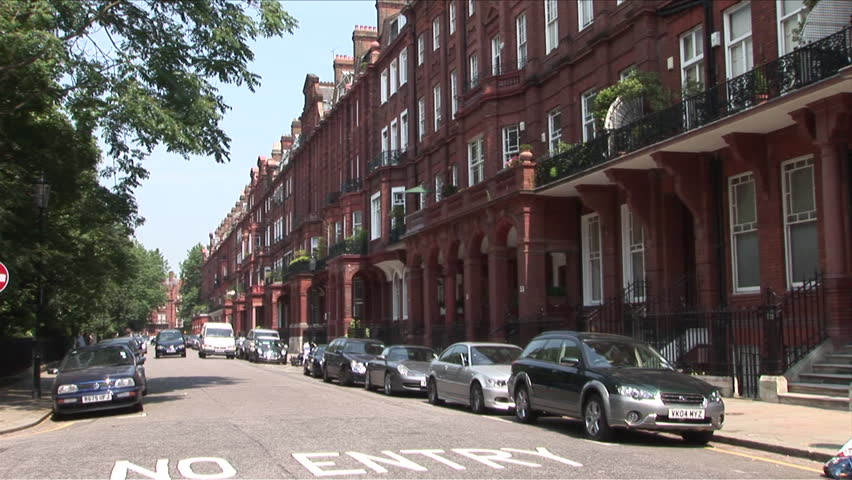 London, England - CIRCA June, 2006: A quiet street with many cars parallel parked as space is at a premium in most areas of the city