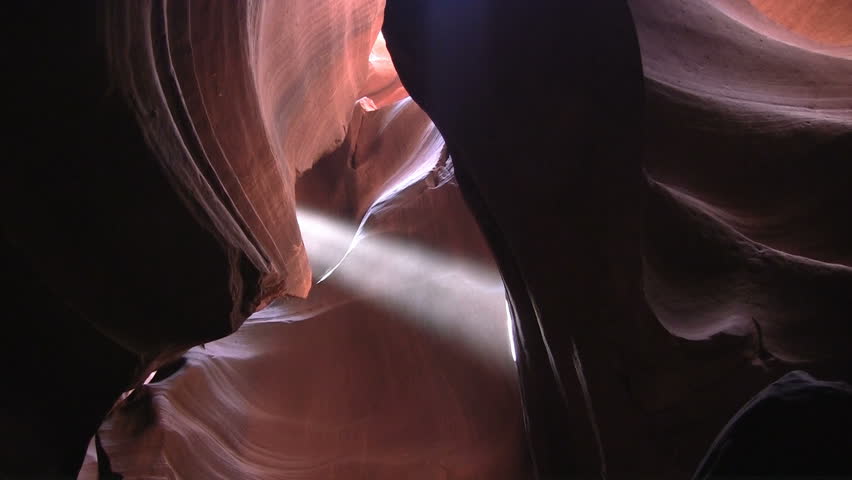 Light beam illuminates dust and rain in Antelope Canyon, Arizona (pan)