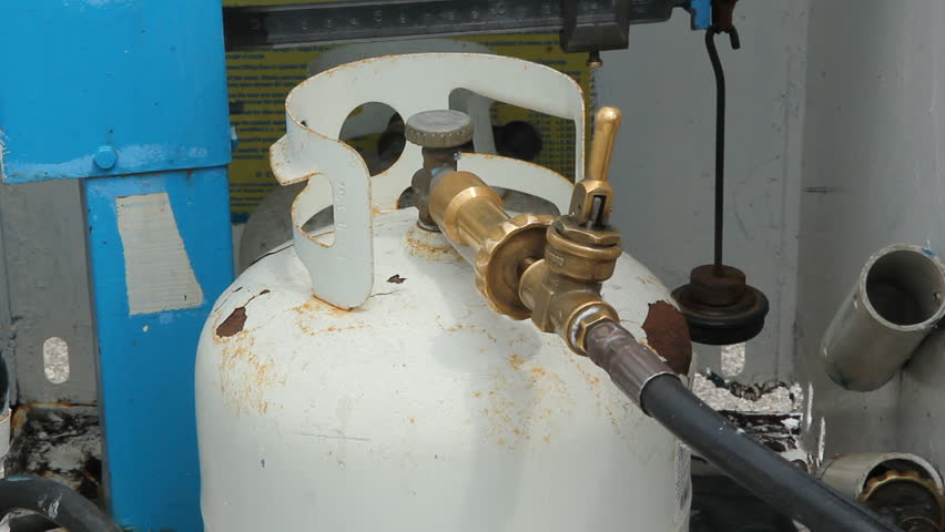 TORONTO, CANADA JUNE 12th: Removing a filled propane tank on June 12th, 2012. Propane is one of a group of liquefied petroleum gases.