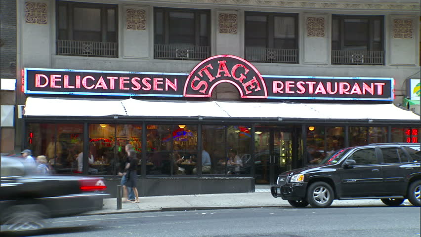 New York, NY - CIRCA 2006: Traffic drives past a delicatessen in Manhattan during the day