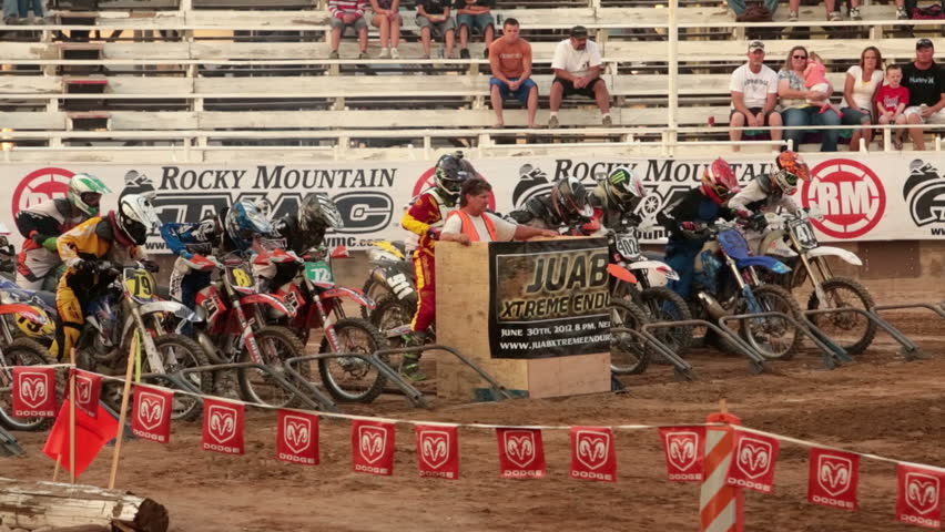 NEPHI, JUAB, UTAH 30 JUN 2012: Economic boost to rural community in annual race.  Motorcycle race start slow motion. Juab County extreme enduro. Hard riding and dangerous motor vehicle event.