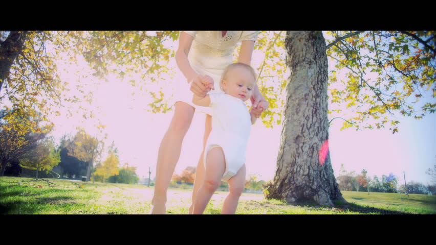 Close up of a young mother holding her baby while he plays with her hair shot in 5K widescreen RED EPIC