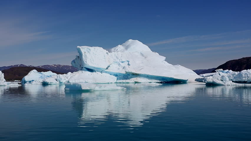 Drifting by an iceberg floating in Qooroq Icefjord, South Greenland