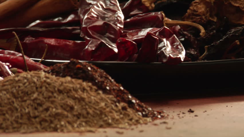slow pan over peppers and a mountain of mexican spices