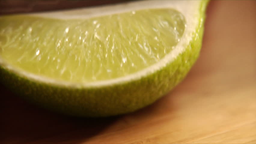 Follows action as chef slices a lime