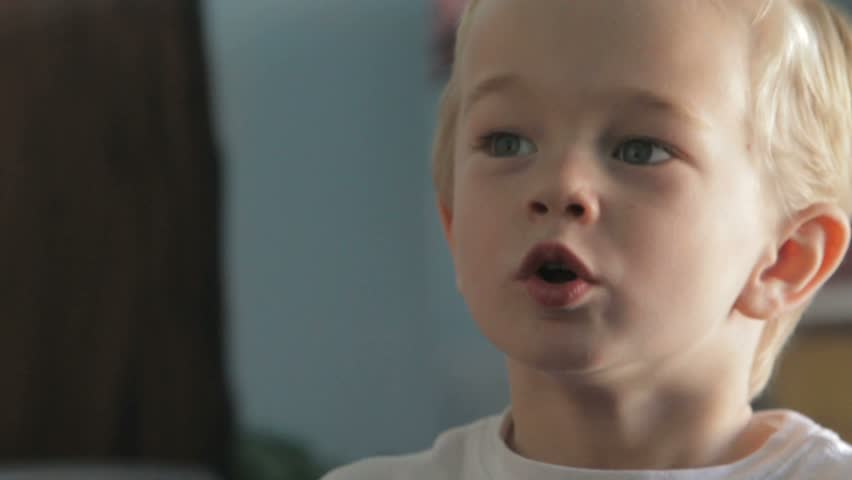 Little boy singing with classmates in preschool