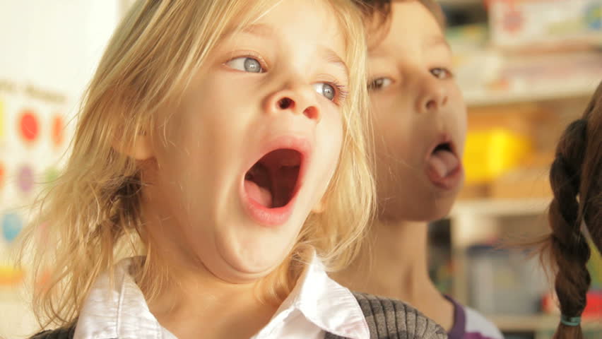 Little girl yawing during a lesson in preschool